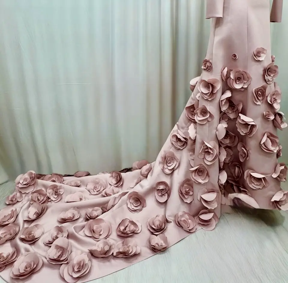 Blush satin gown with a train covered in hand-made 3D roses