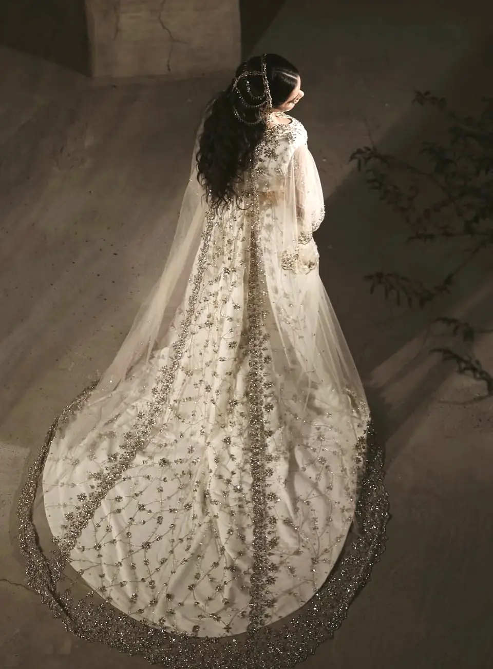 Ivory bridal gown with gold and crystal embroidery and a scalloped cathedral train, seen from above
