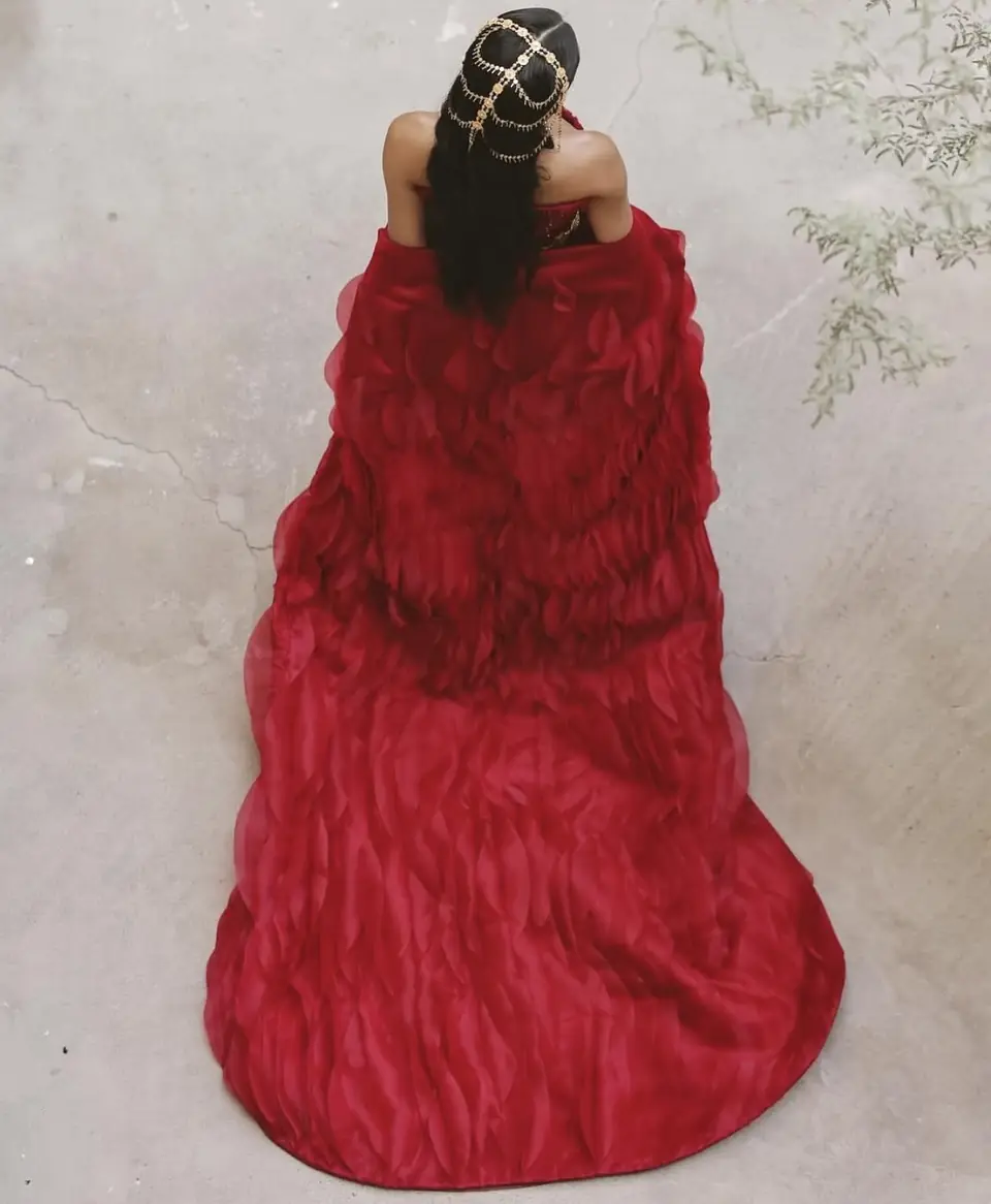 Red organza petal cape and train seen from above