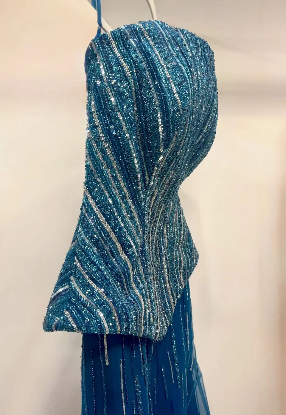 Teal sculpted peplum bodice hand-beaded with silver and iridescent lines